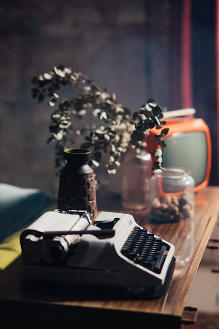 Vintage Typewriter and Television on Wooden Table